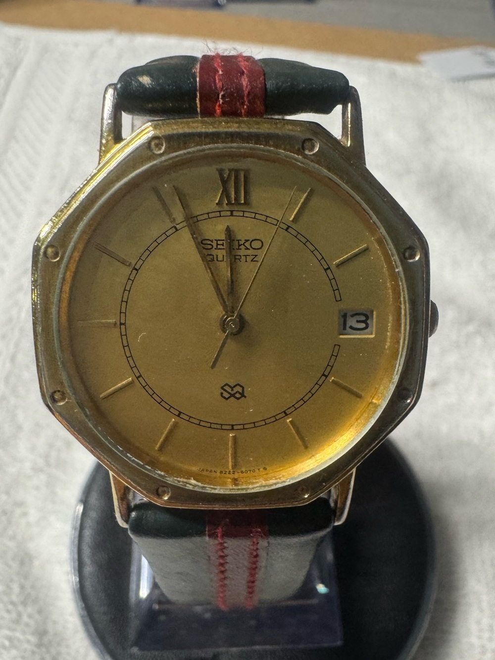 Seiko Gold Dial Watch with Black Strap and Red Stitch